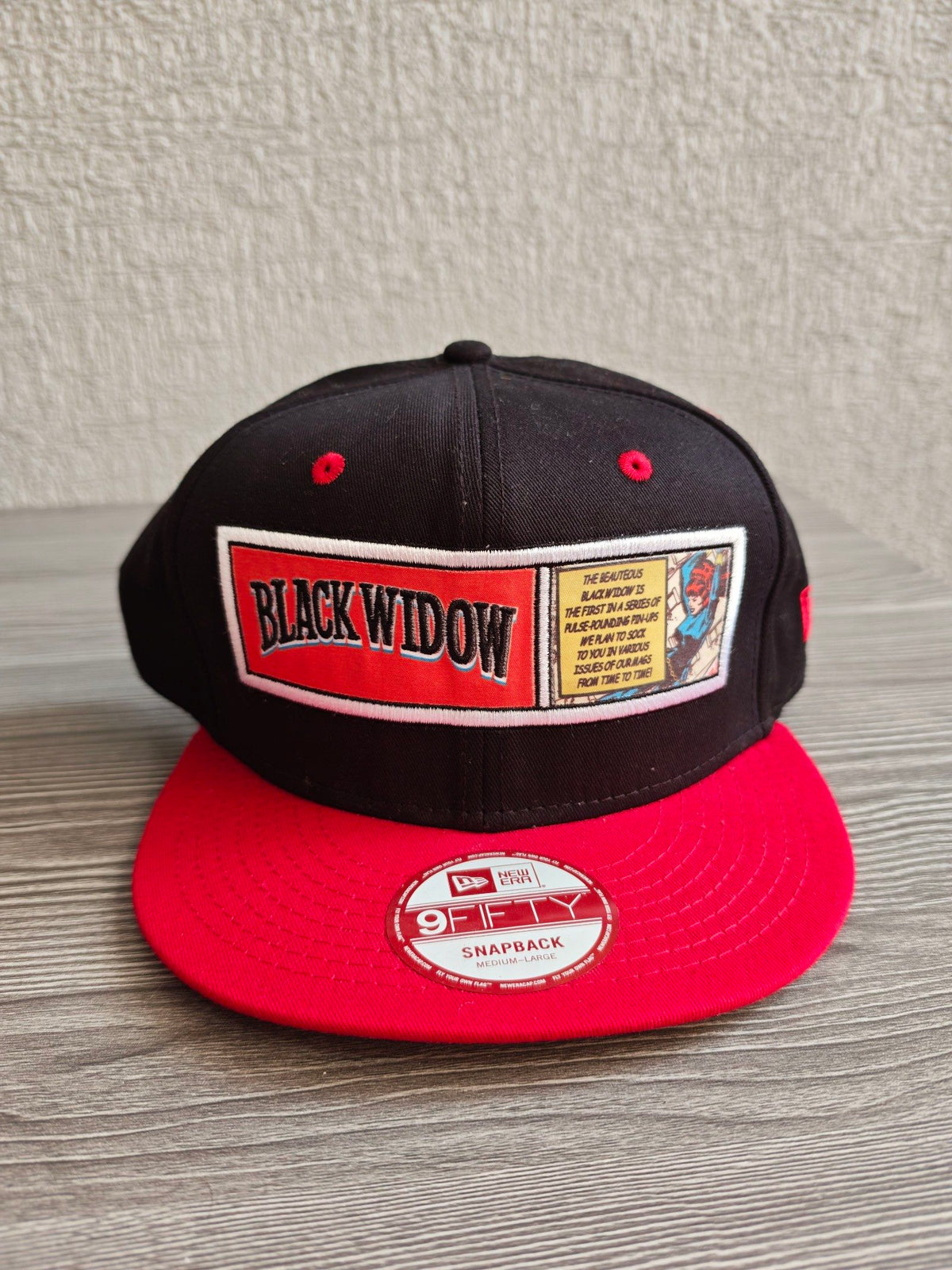 New Era snapback cap black and red with embroidered Black Widow patch and Marvel branding.