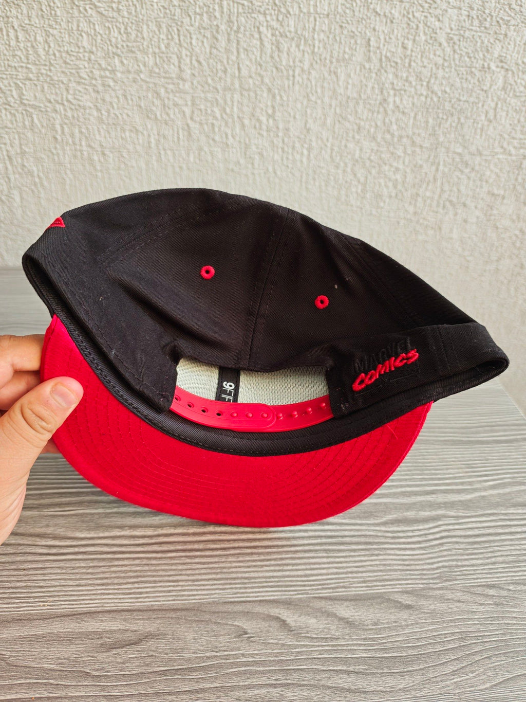 New Era snapback cap black and red with embroidered Black Widow patch and Marvel branding.