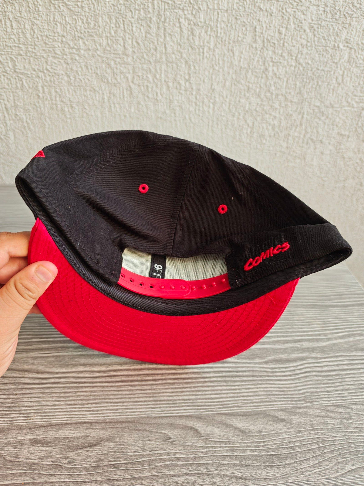 New Era snapback cap black and red with embroidered Black Widow patch and Marvel branding.