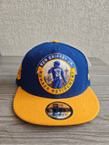 New Era blue and yellow snapback cap with embroidered Ken Griffey Jr. details.