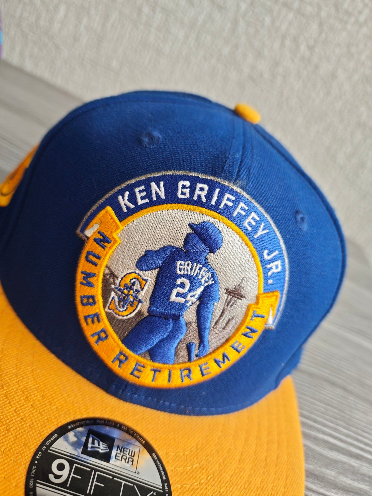 New Era blue and yellow snapback cap with embroidered Ken Griffey Jr. details.