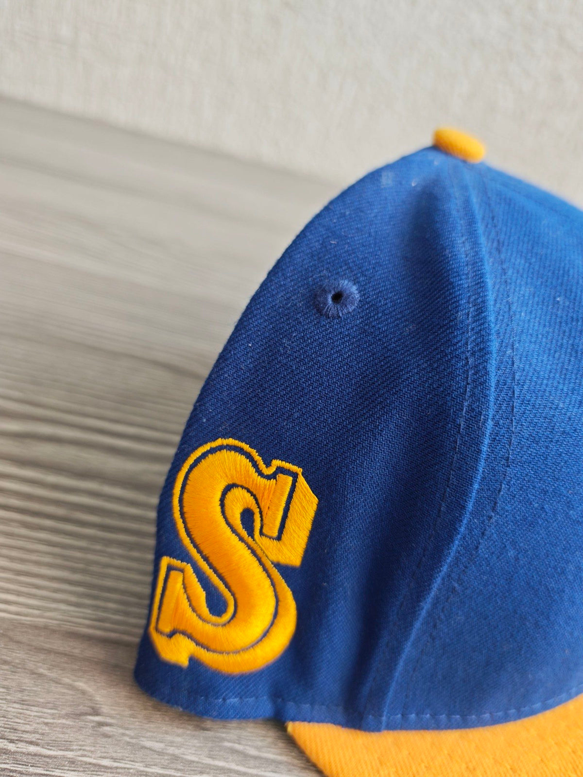 New Era blue and yellow snapback cap with embroidered Ken Griffey Jr. details.