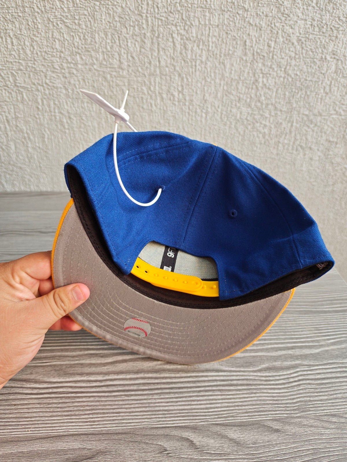 New Era blue and yellow snapback cap with embroidered Ken Griffey Jr. details.