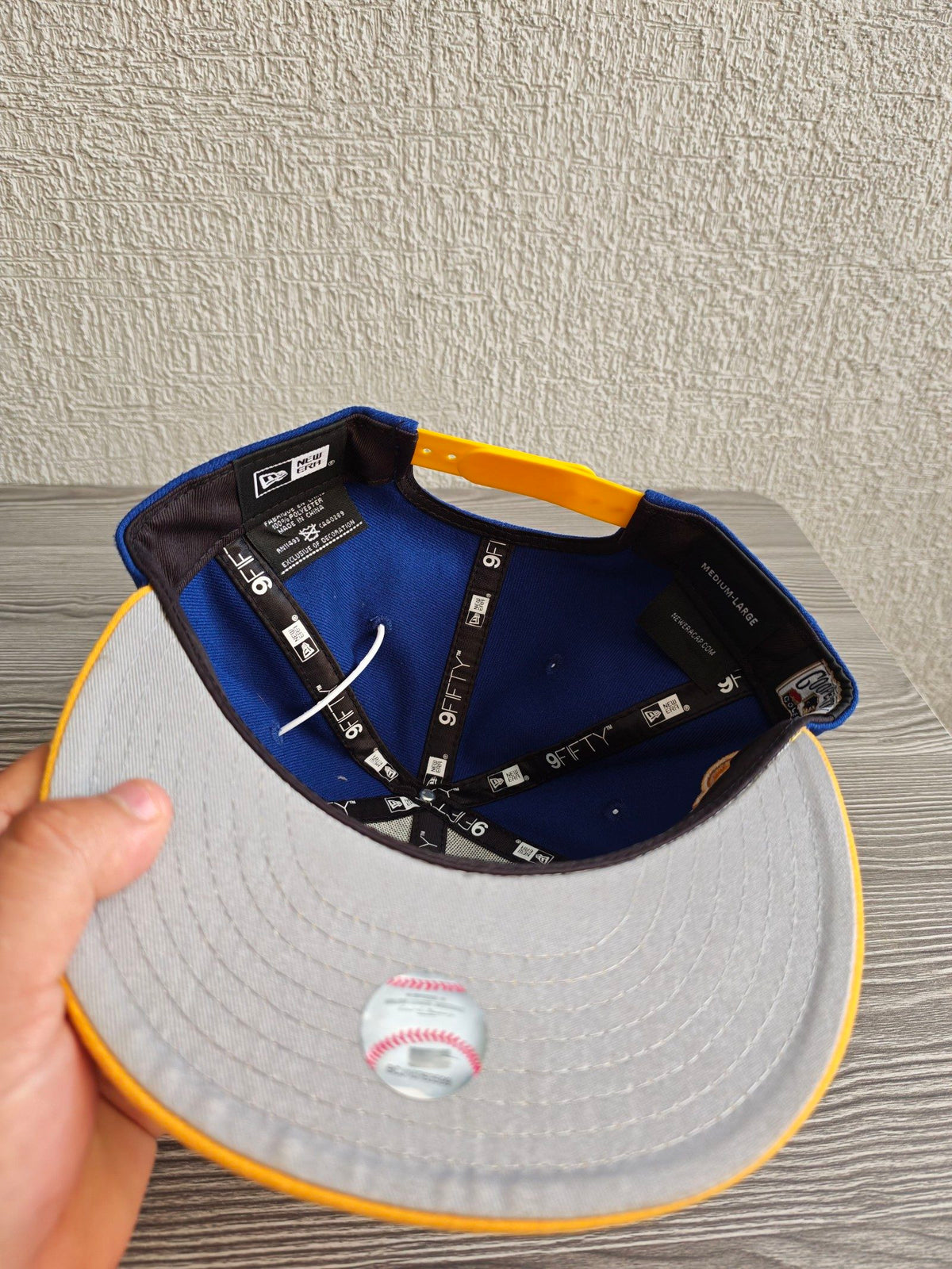New Era blue and yellow snapback cap with embroidered Ken Griffey Jr. details.