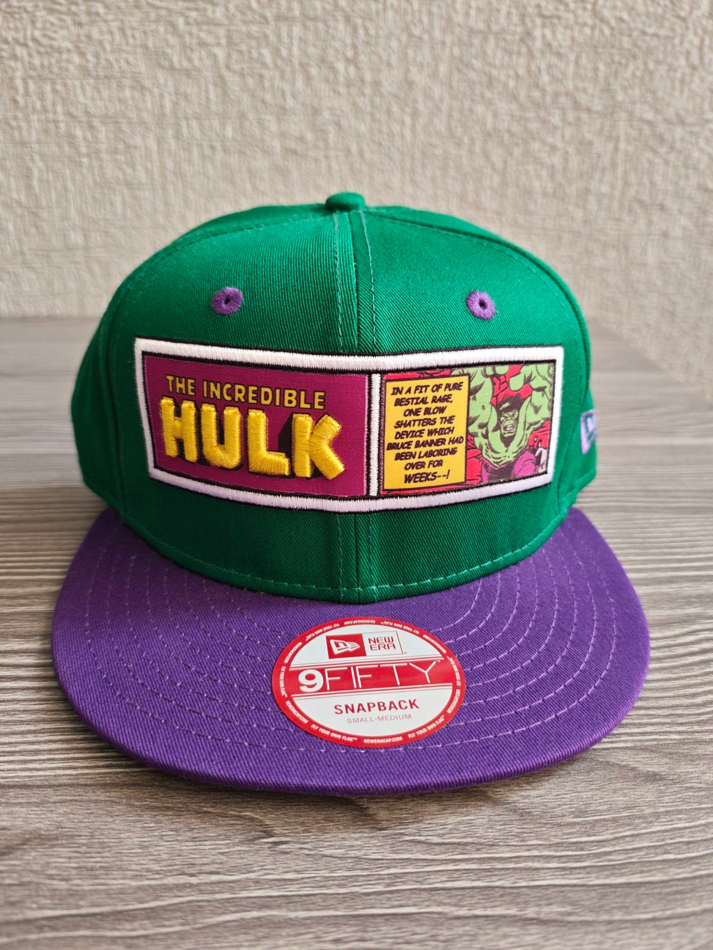 New Era green snapback hat with purple visor and embroidered Incredible Hulk patch.