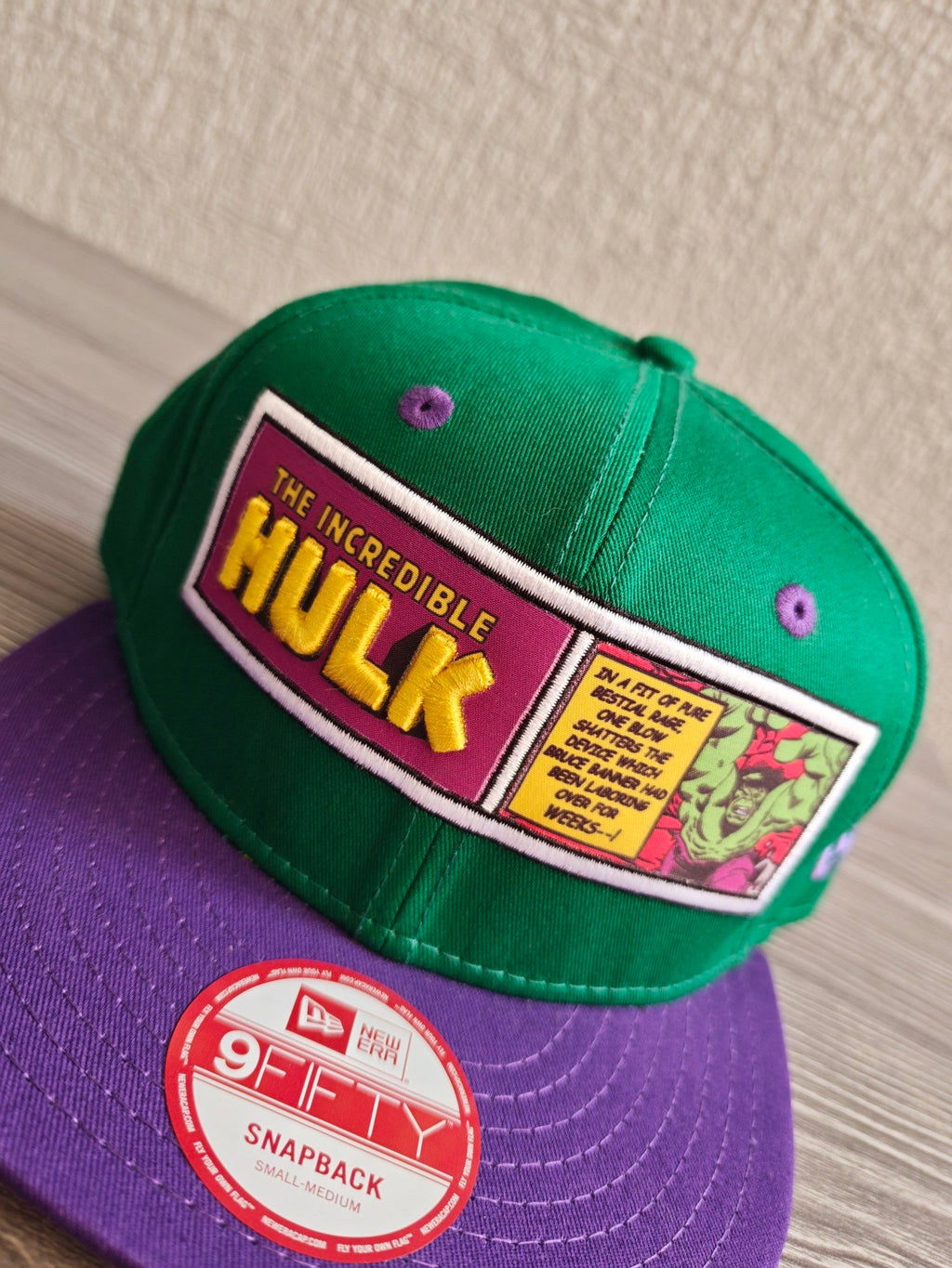 New Era green snapback hat with purple visor and embroidered Incredible Hulk patch.