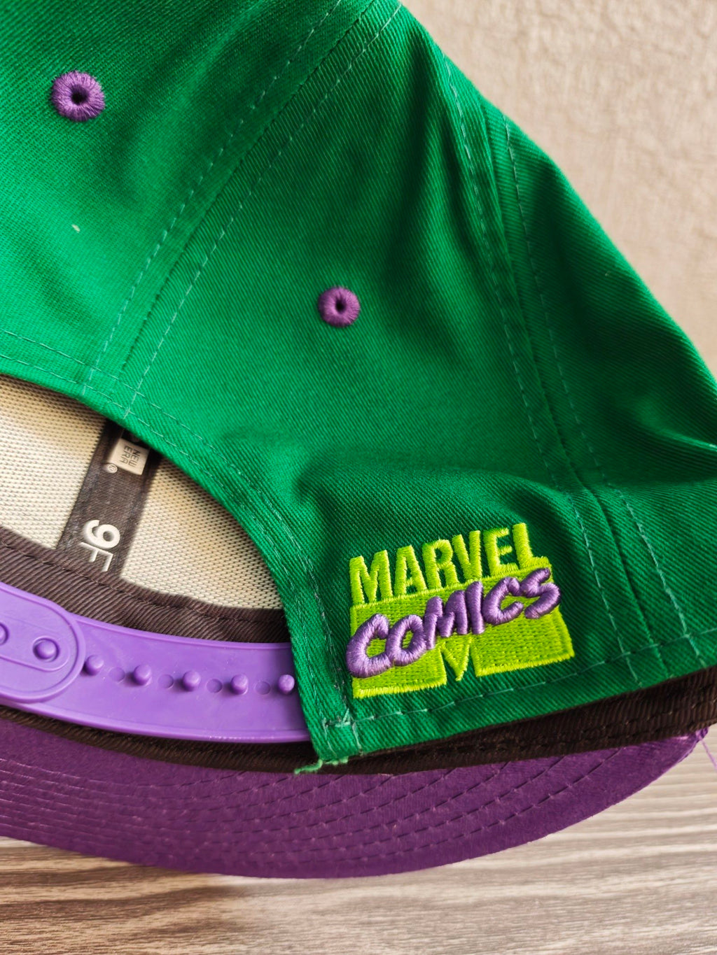 New Era green snapback hat with purple visor and embroidered Incredible Hulk patch.