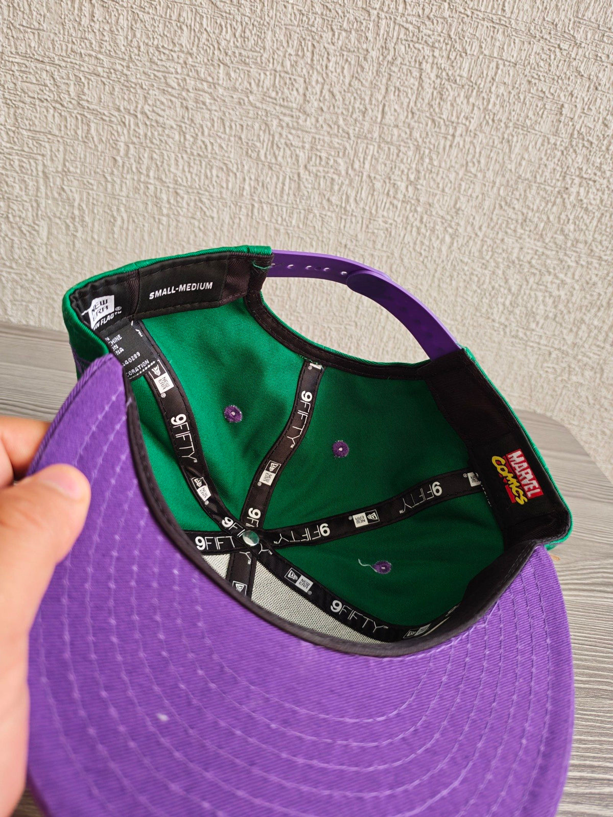 New Era green snapback hat with purple visor and embroidered Incredible Hulk patch.