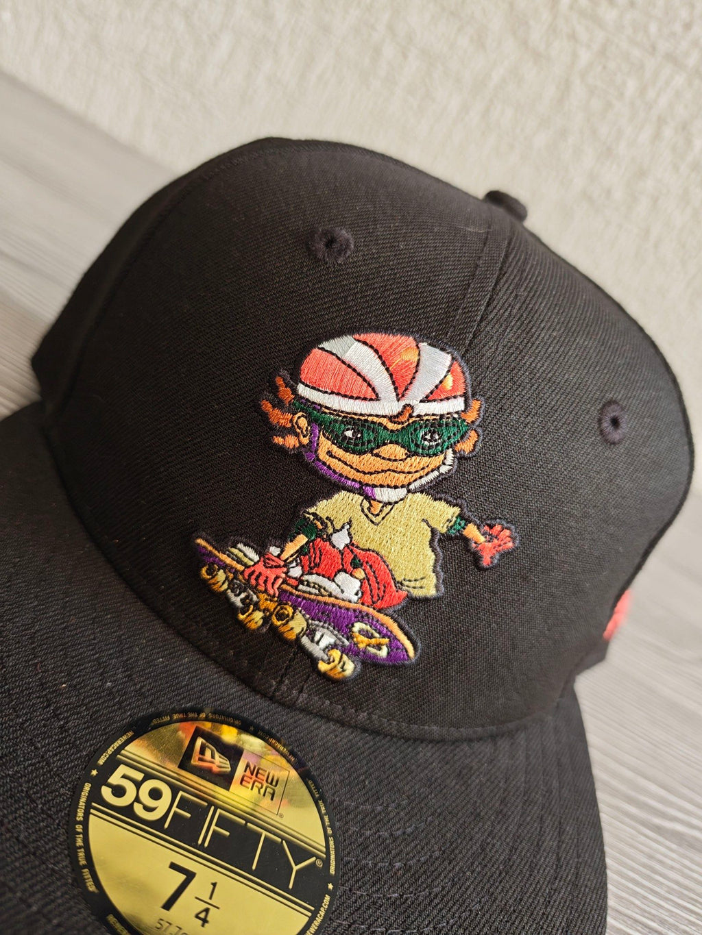 New Era black fitted cap with Rocket Power character embroidery and colorful details.