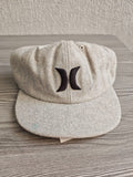 Hurley grey wool baseball cap with black embroidered logo and six ventilation eyelets.