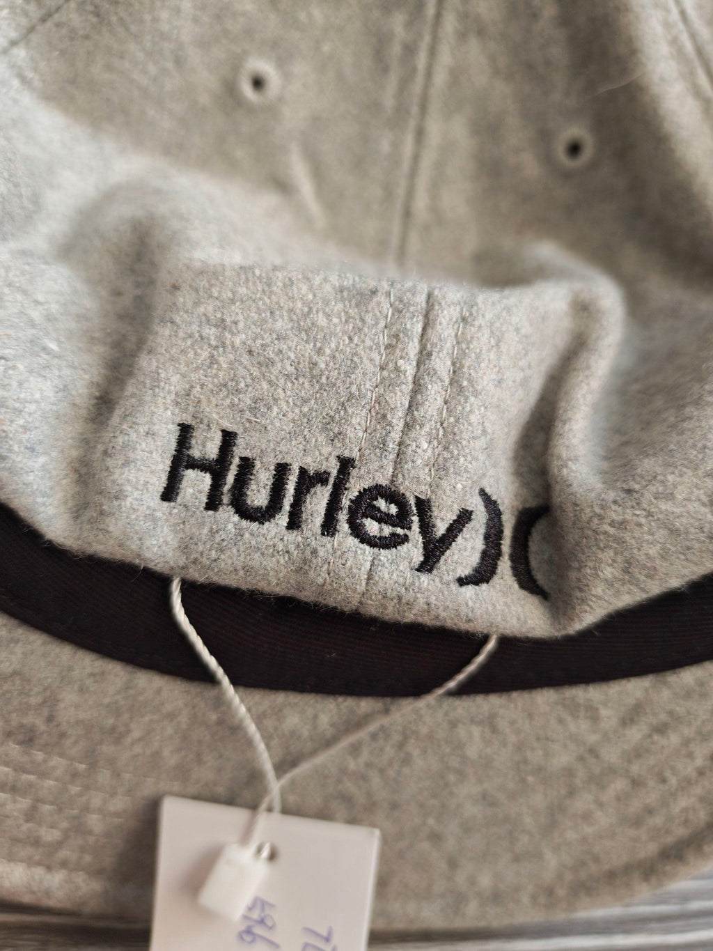 Hurley grey wool baseball cap with black embroidered logo and six ventilation eyelets.