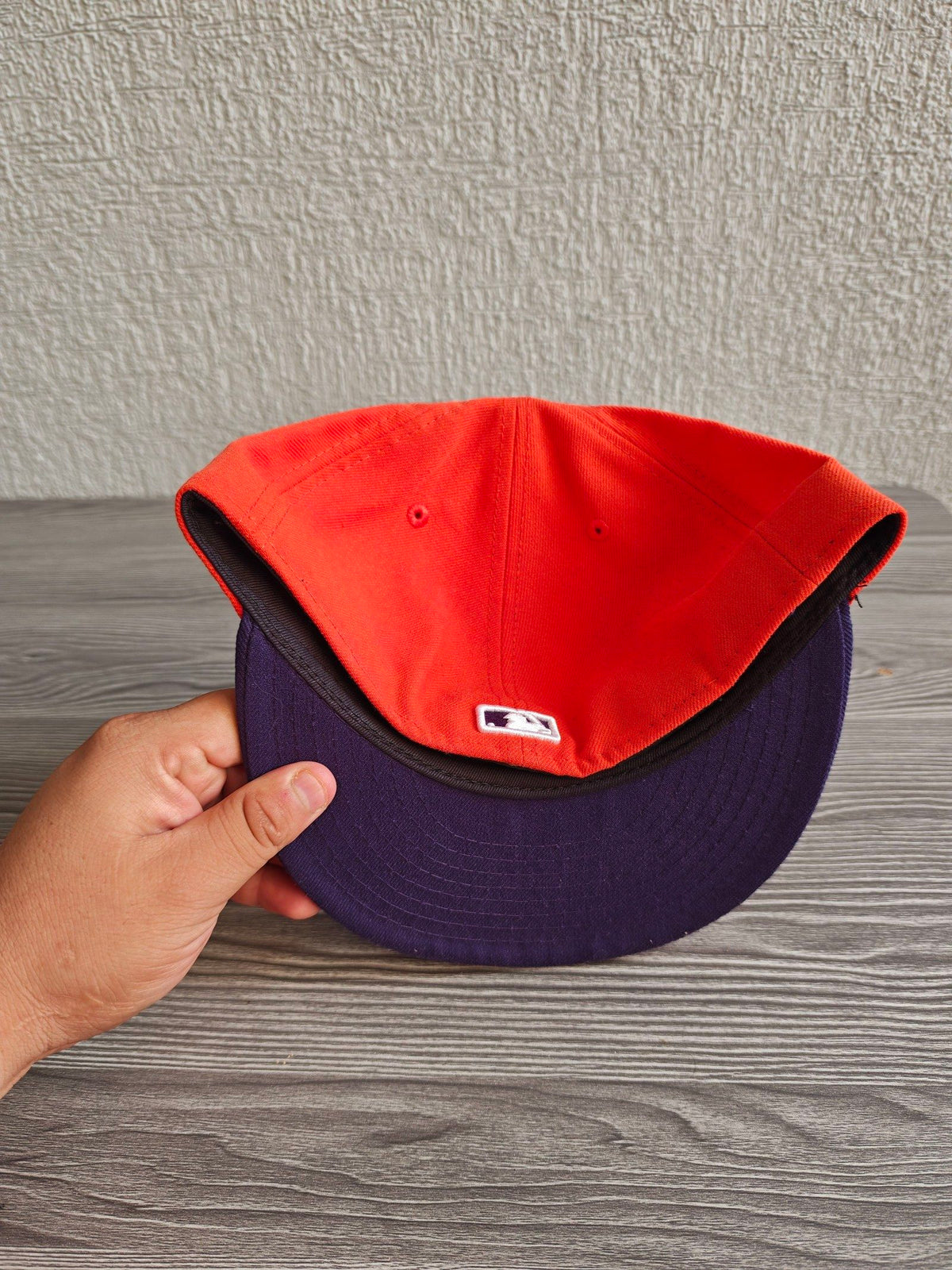 New Era orange and purple New York Yankees cap with embroidered logo and fitted design.