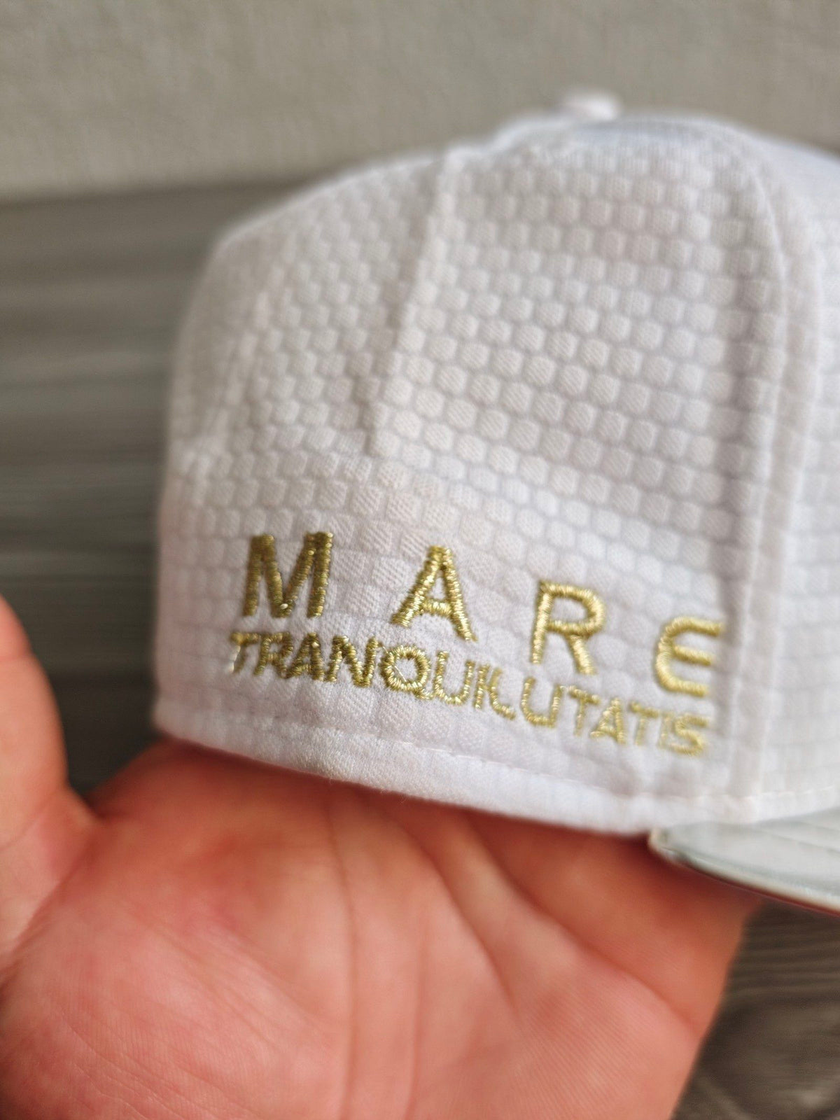 New Era red snapback cap with white textured fabric and embroidered lunar landing patch.