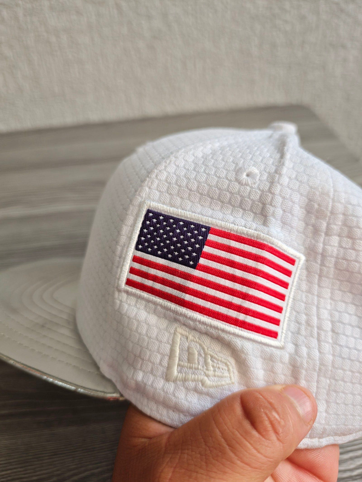 New Era red snapback cap with white textured fabric and embroidered lunar landing patch.