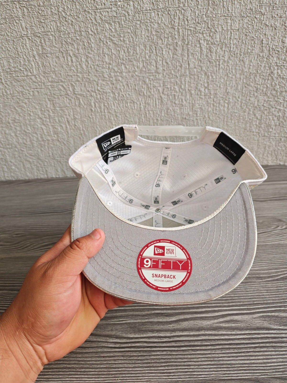 New Era red snapback cap with white textured fabric and embroidered lunar landing patch.