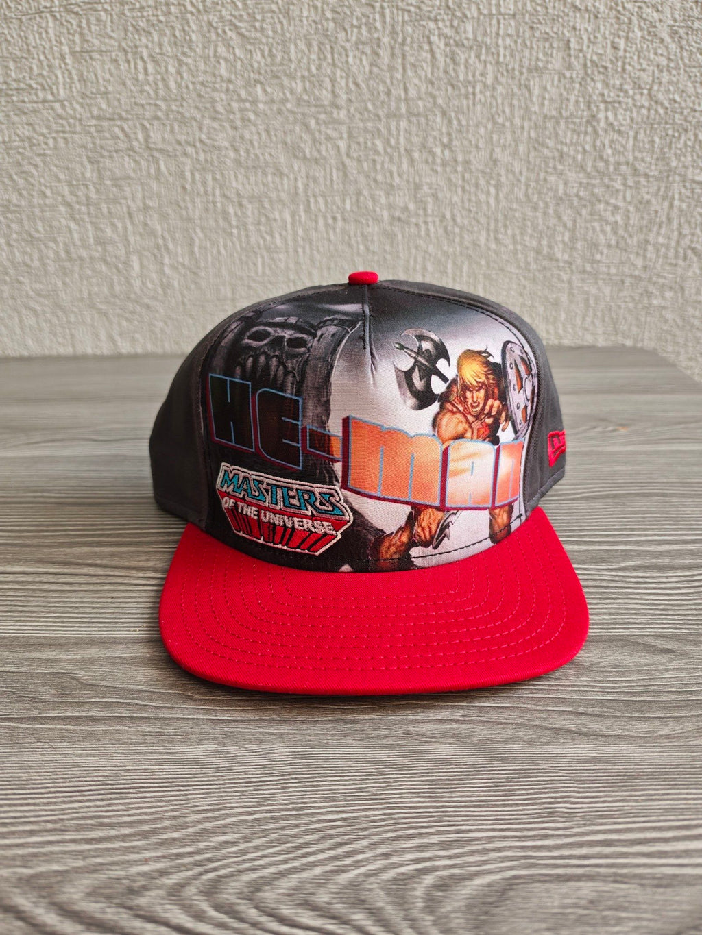 New Era grey snapback cap with red flat brim and Masters of the Universe graphic.