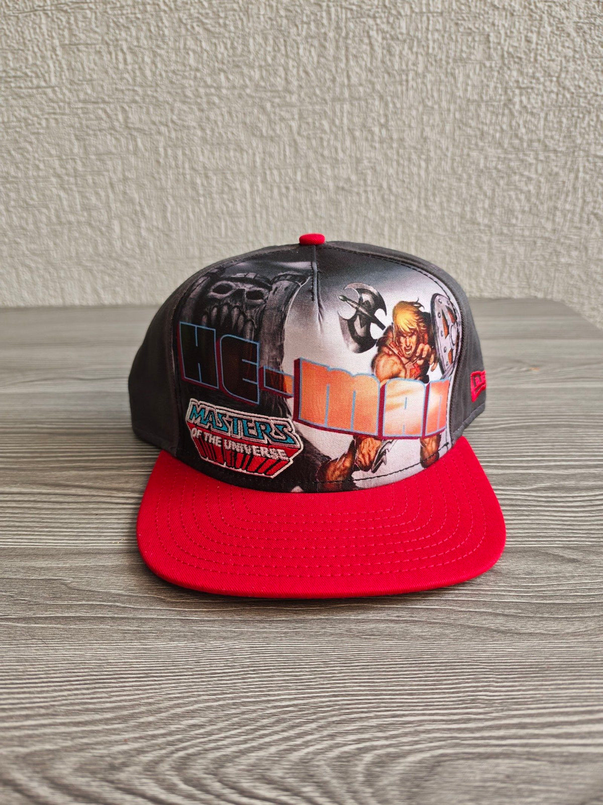 New Era grey snapback cap with red flat brim and Masters of the Universe graphic.