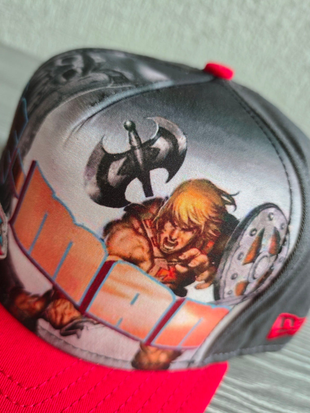 New Era grey snapback cap with red flat brim and Masters of the Universe graphic.