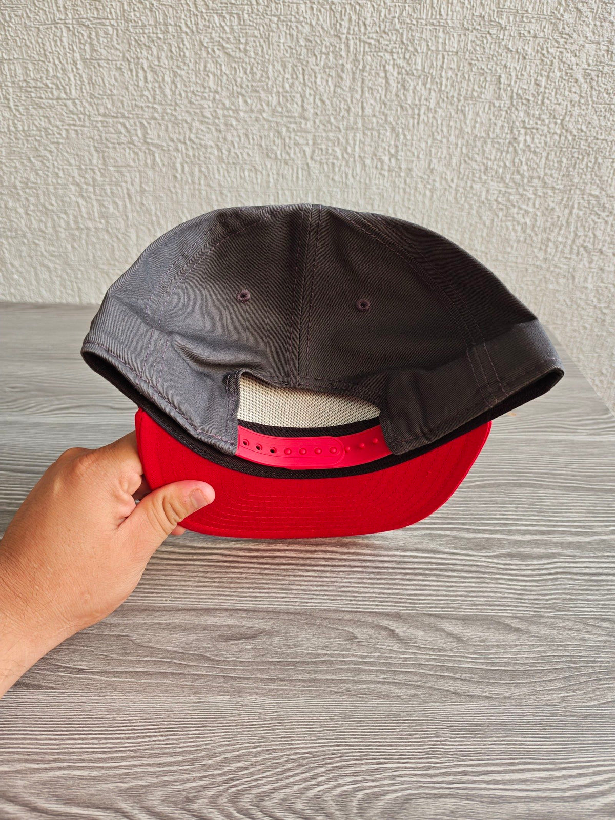 New Era grey snapback cap with red flat brim and Masters of the Universe graphic.