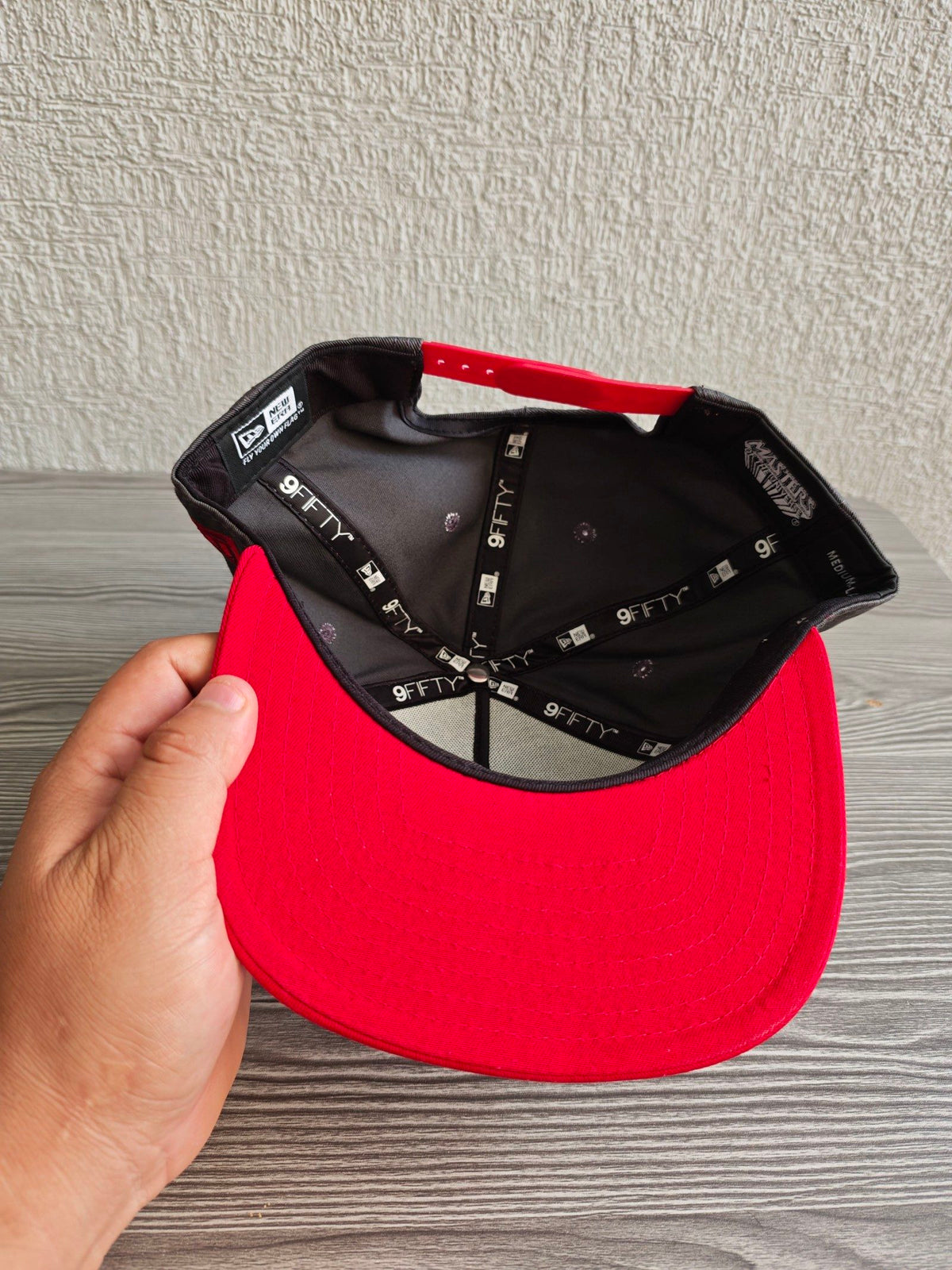 New Era grey snapback cap with red flat brim and Masters of the Universe graphic.
