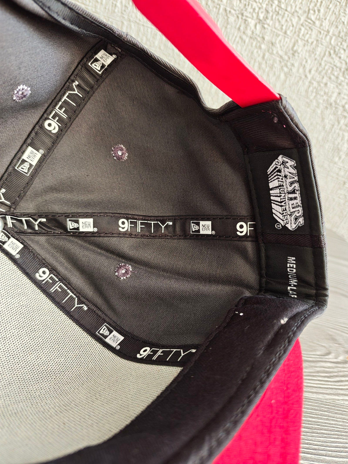 New Era grey snapback cap with red flat brim and Masters of the Universe graphic.