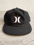 Hurley black fitted cap with white embroidered logos, 100% wool, New Era model.