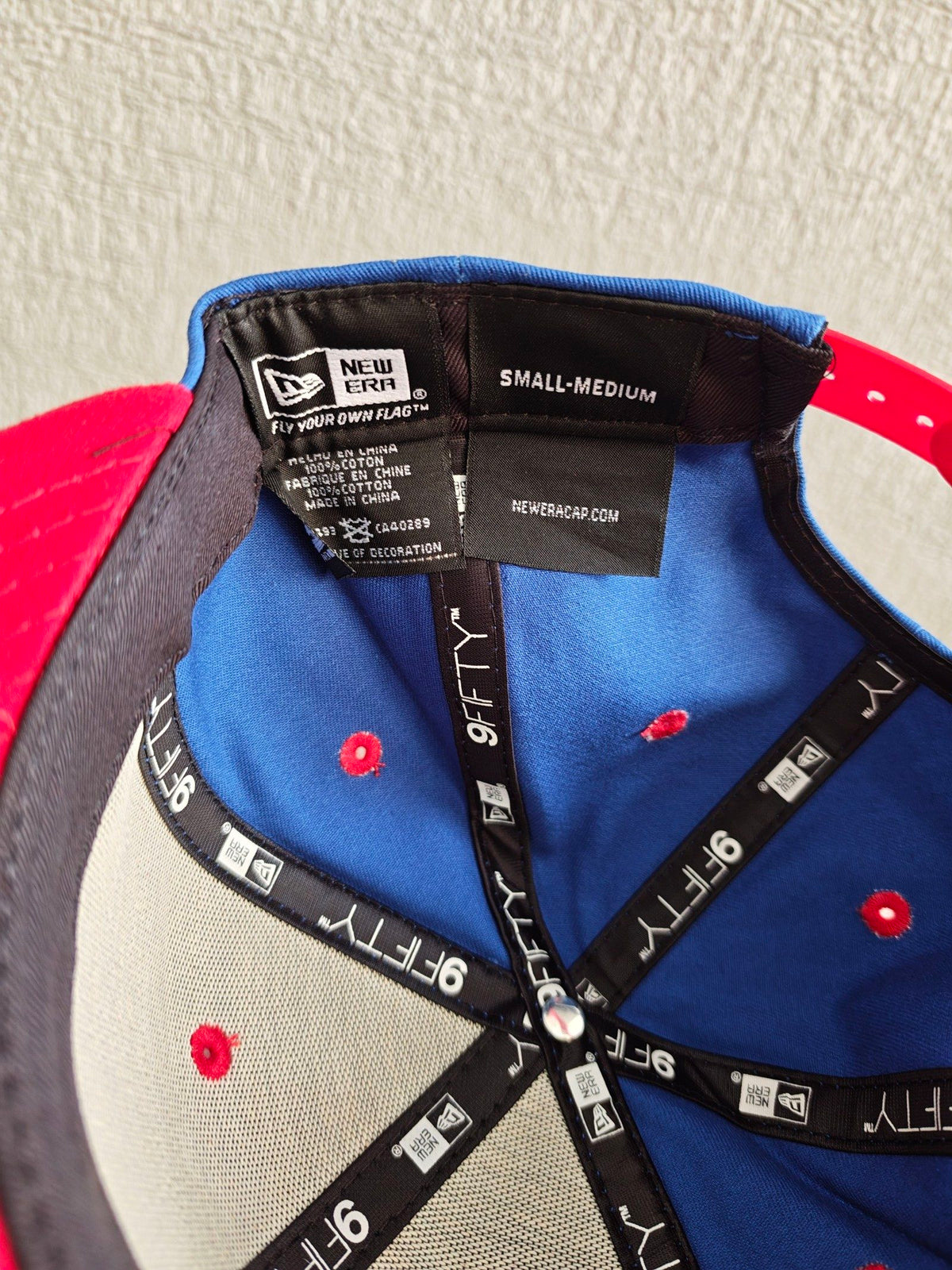New Era blue and red snapback hat with Captain America comic patch and Marvel logo.