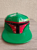 New Era black and green fitted cap with Boba Fett helmet design and space-themed lining.