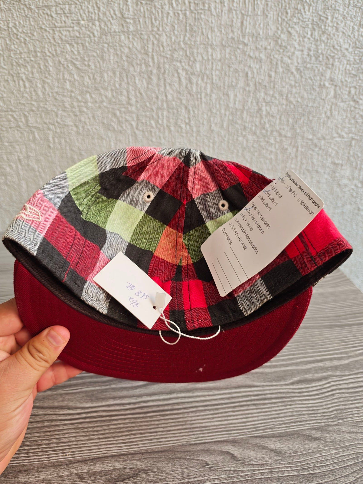 New Era red and cream fitted cap with CA logo and multicolored plaid pattern.