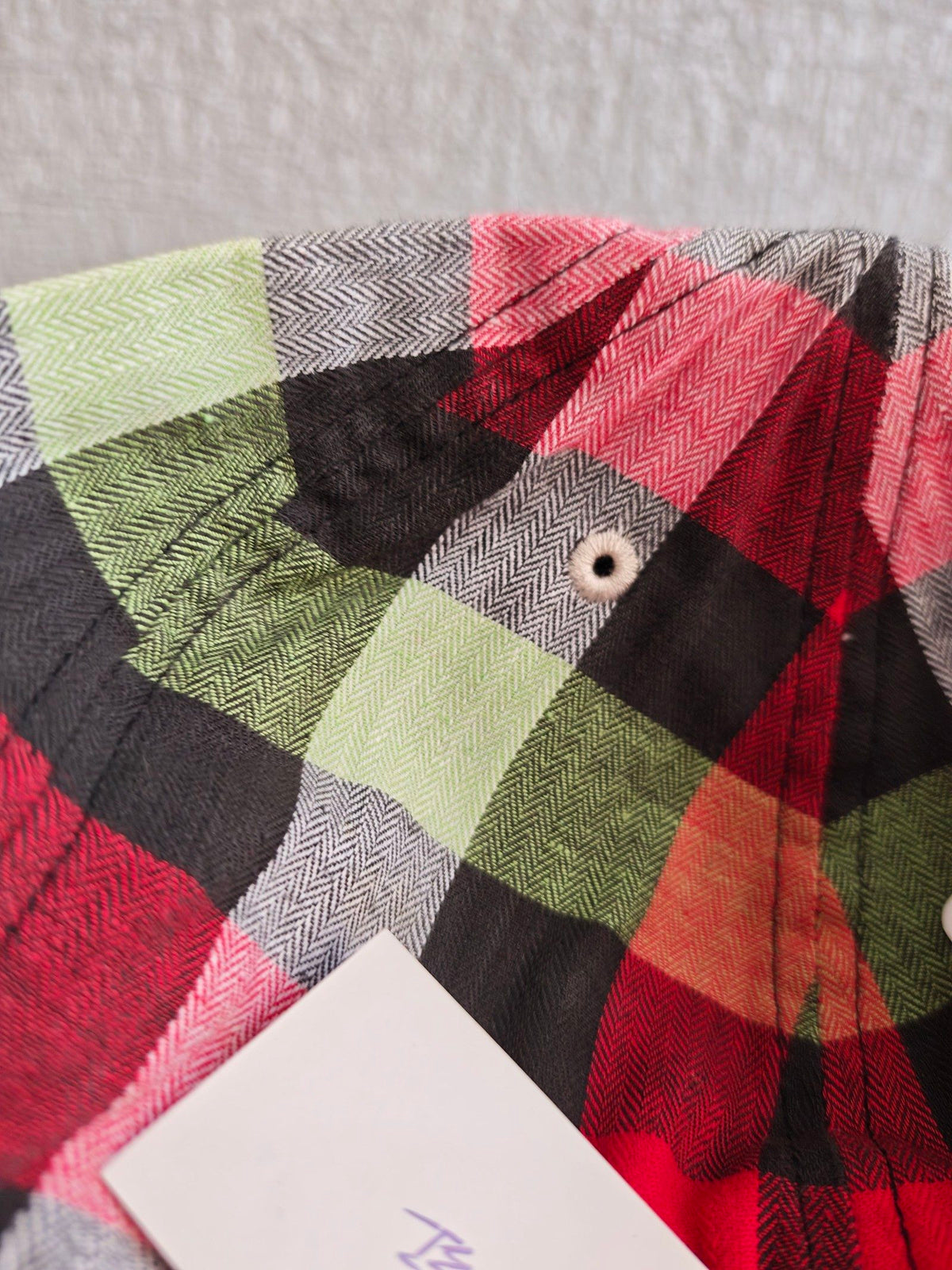 New Era red and cream fitted cap with CA logo and multicolored plaid pattern.